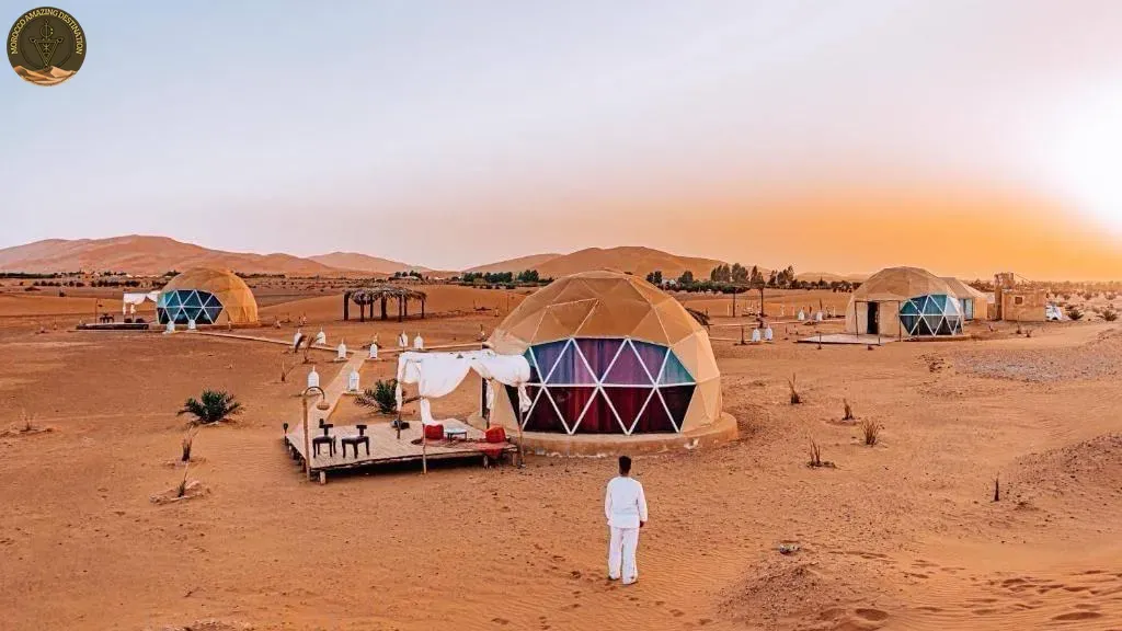 Illuminated desert camp among the dunes near Merzouga